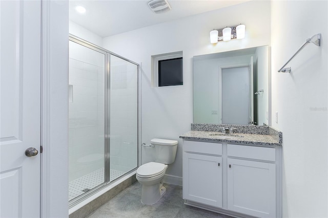 bathroom with vanity, toilet, and a shower with shower door