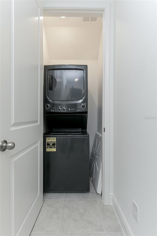 interior space with stacked washing maching and dryer