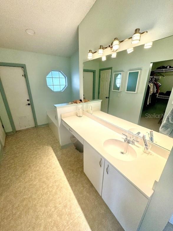 bathroom with vanity and a textured ceiling