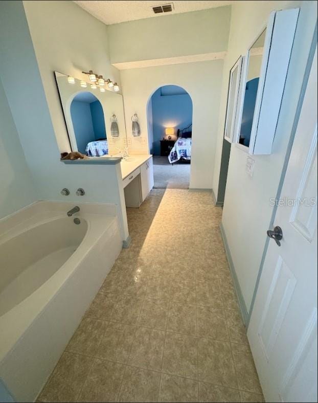 bathroom with vanity and a bathing tub