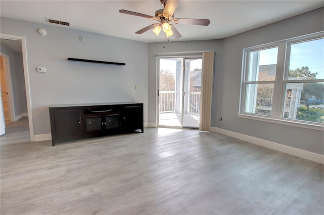 unfurnished living room featuring light wood-type flooring and ceiling fan