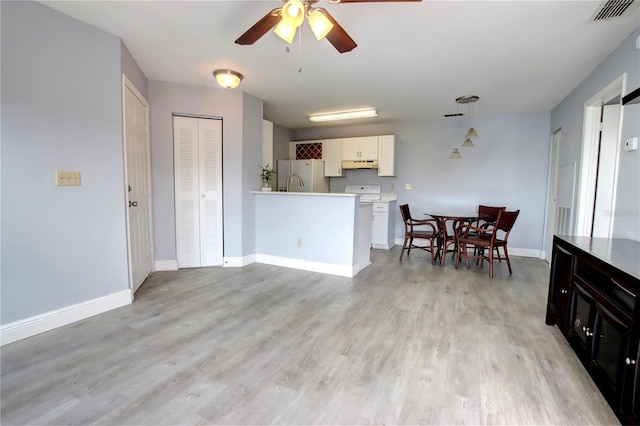 kitchen featuring decorative light fixtures, white refrigerator, light hardwood / wood-style floors, and ceiling fan