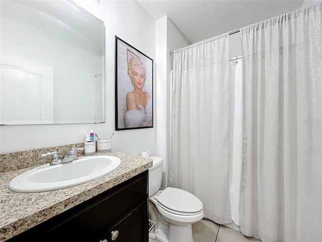 bathroom with tile patterned flooring, vanity, and toilet