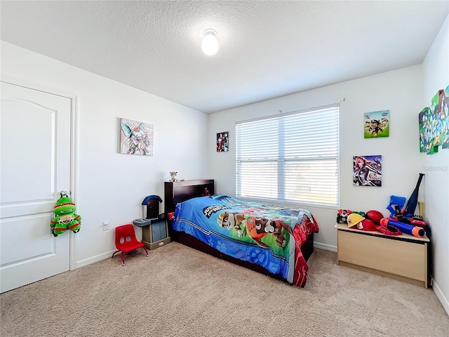 bedroom featuring light colored carpet and a textured ceiling