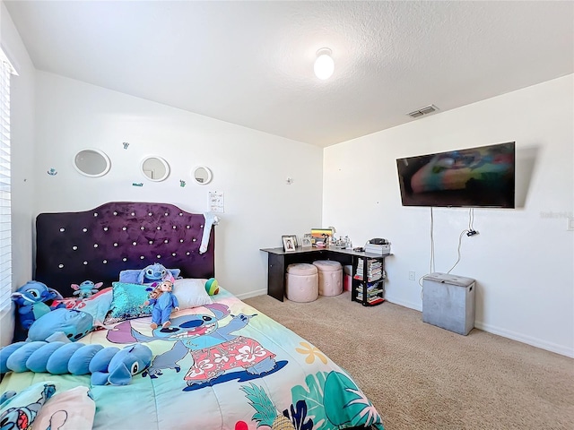 carpeted bedroom with a textured ceiling