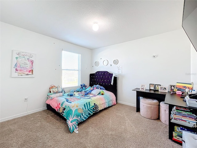 bedroom with carpet and a textured ceiling