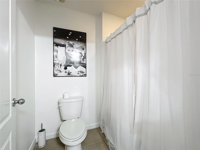 bathroom with tile patterned floors and toilet