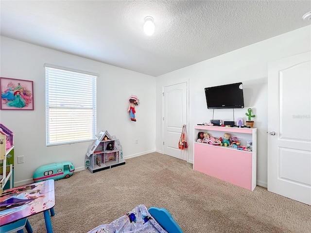 game room with carpet floors and a textured ceiling