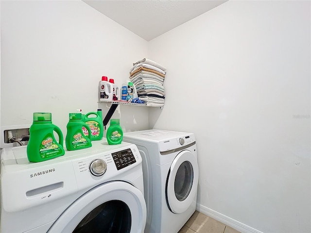 washroom featuring light tile patterned floors and independent washer and dryer