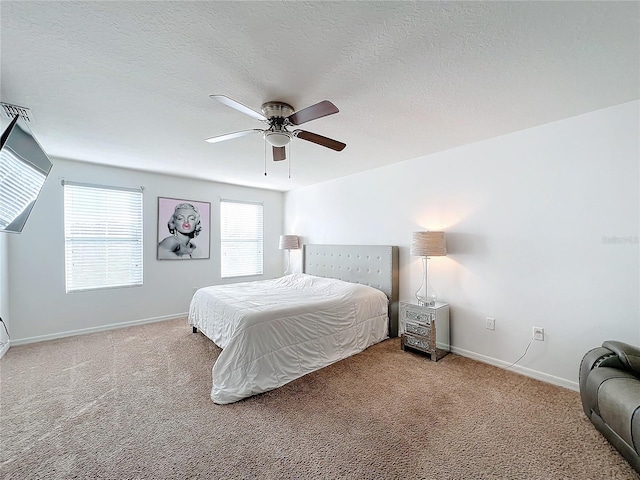 bedroom featuring ceiling fan, carpet floors, and a textured ceiling