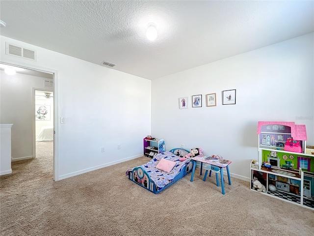 game room featuring carpet floors and a textured ceiling