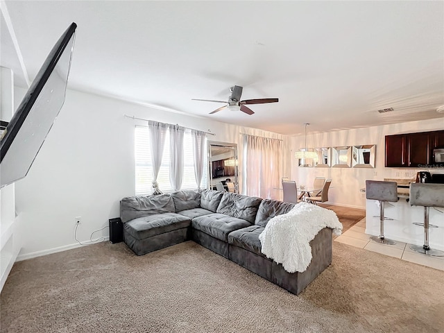 tiled living room with ceiling fan