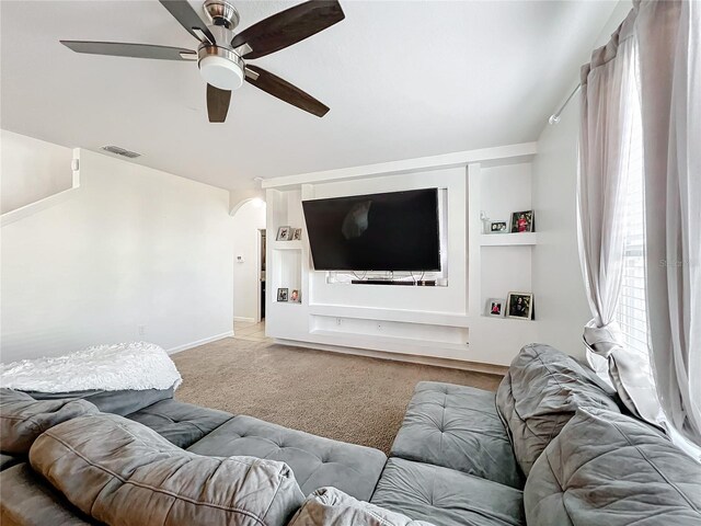 carpeted living room with ceiling fan