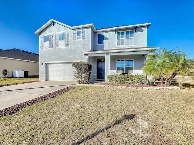 view of front of property featuring a garage and a front lawn