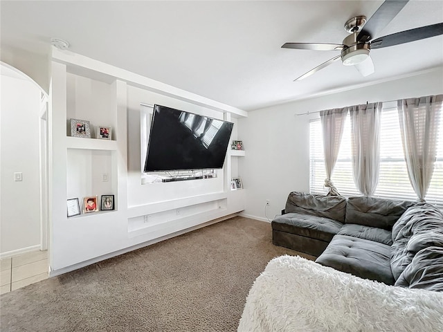 carpeted living room featuring ceiling fan