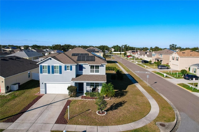 view of front of property with driveway, stucco siding, a front lawn, a garage, and a residential view
