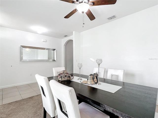 6163 Forest Ridge Way, Winter Haven, FL 33881 - carpeted dining room with arched walkways, ceiling fan, tile patterned floors, and baseboards
