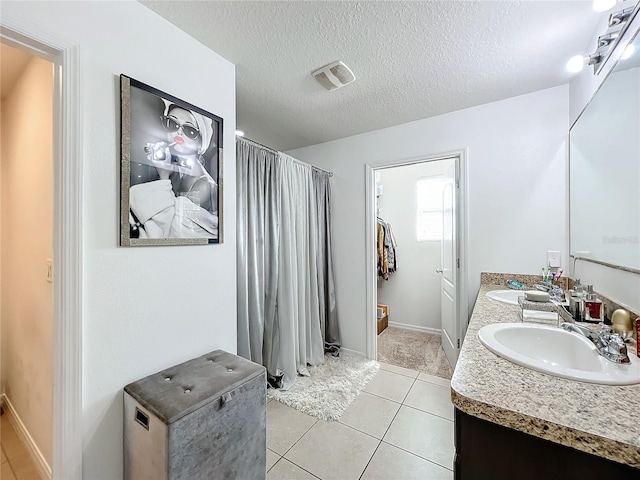 6163 Forest Ridge Way, Winter Haven, FL 33881 - full bath with double vanity, curtained shower, tile patterned floors, a textured ceiling, and baseboards