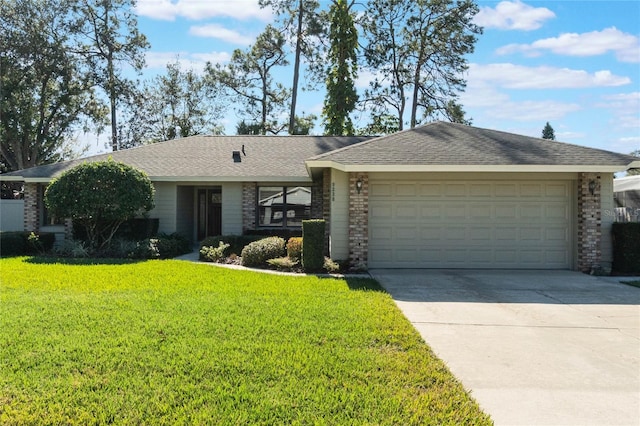 single story home with a garage and a front lawn