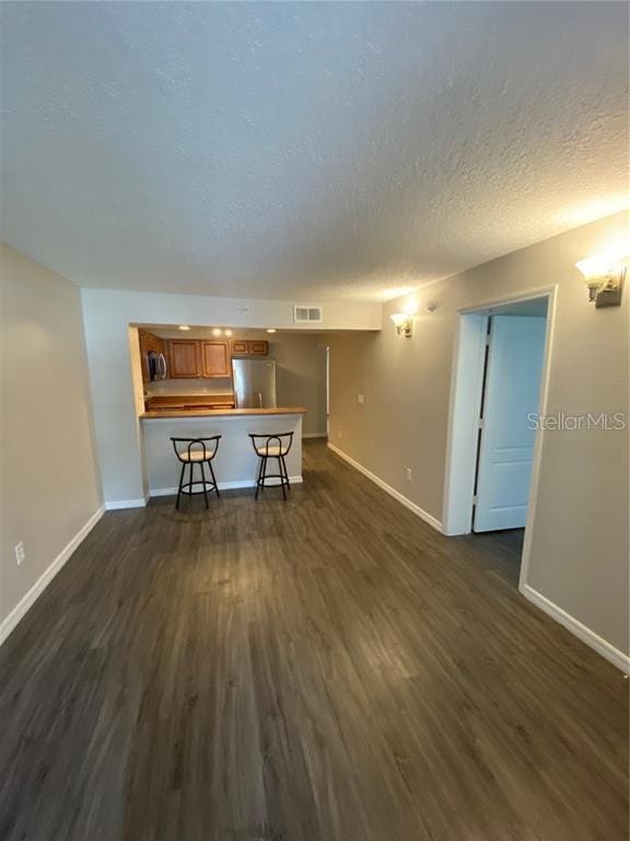 unfurnished living room with dark hardwood / wood-style flooring