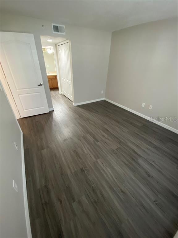 spare room with dark hardwood / wood-style floors