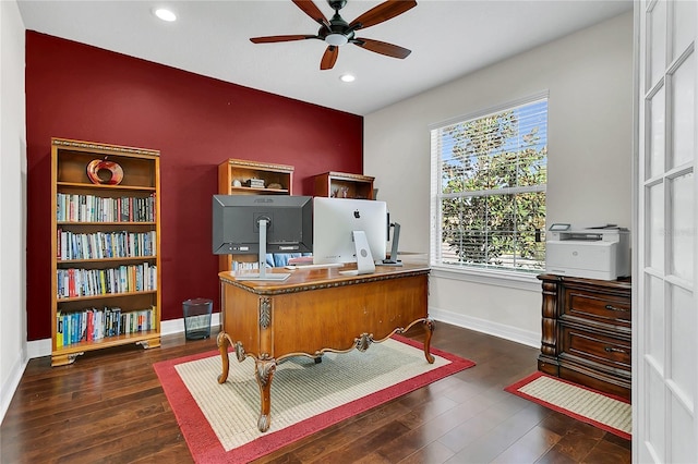 office area featuring a healthy amount of sunlight, ceiling fan, and dark wood-type flooring