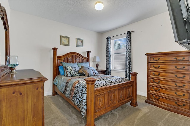 bedroom featuring a textured ceiling and light colored carpet