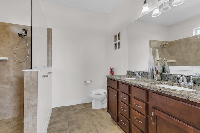 bathroom with a tile shower, tile patterned flooring, vanity, and toilet