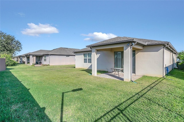 rear view of property with a patio area and a yard