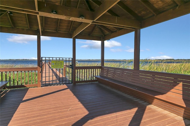 deck with a gazebo and a water view