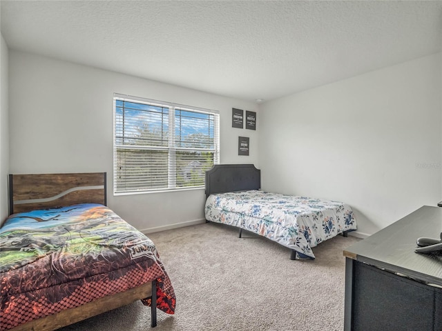 bedroom with carpet floors and a textured ceiling