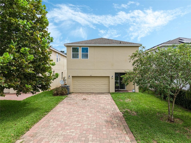 view of front of house featuring a front yard and a garage