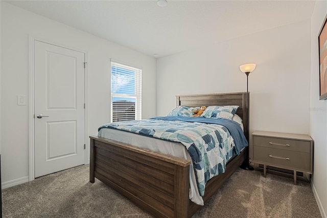 bedroom featuring dark carpet