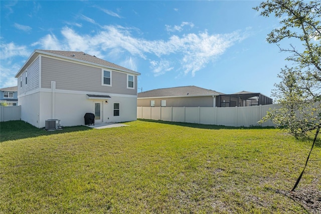 rear view of house featuring a yard, a patio area, and central air condition unit