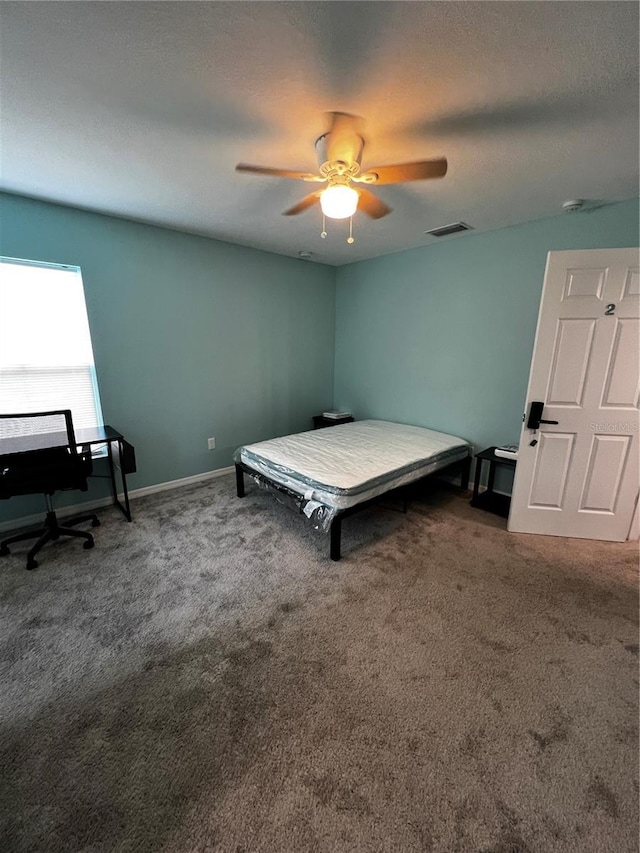 bedroom with ceiling fan and carpet floors