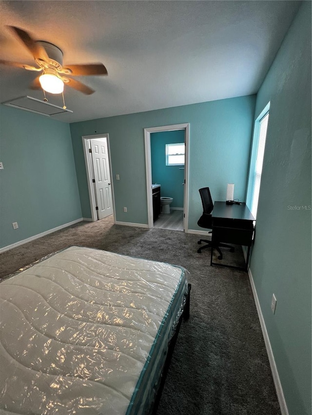 carpeted bedroom with ceiling fan and ensuite bath