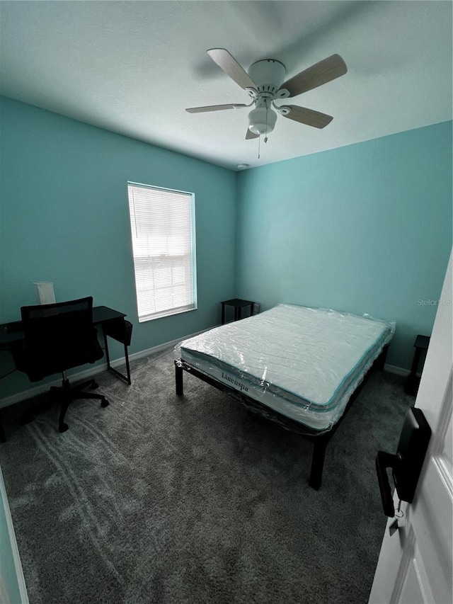 bedroom featuring dark colored carpet and ceiling fan