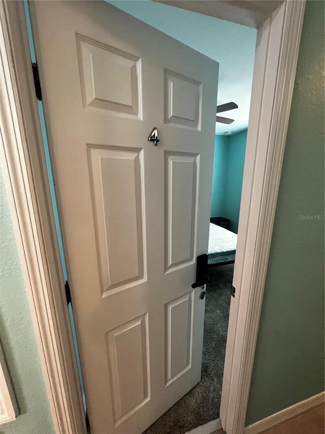 hallway with carpet floors