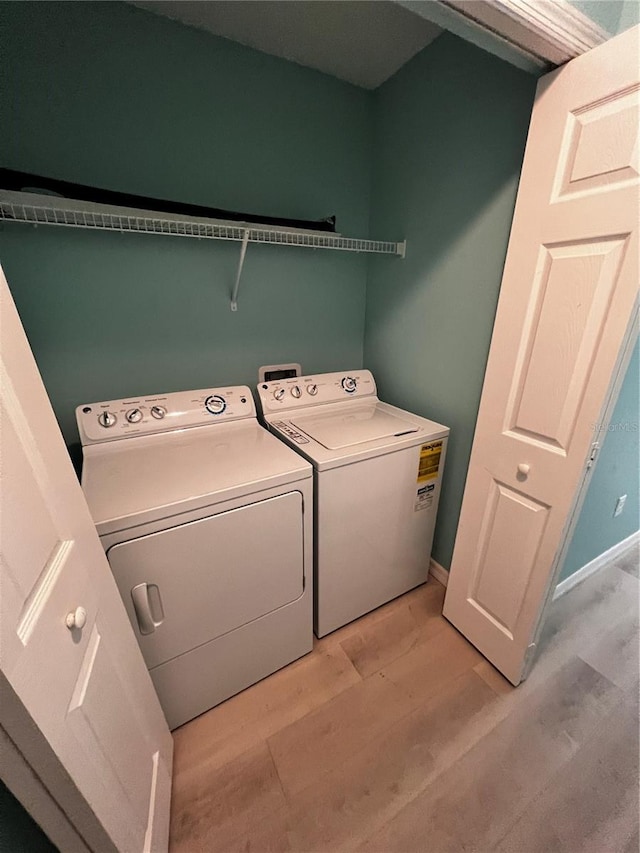 washroom featuring light wood-type flooring and separate washer and dryer