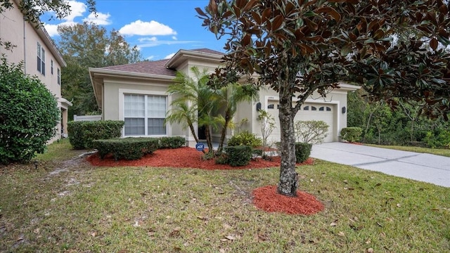 view of front facade with a garage and a front lawn