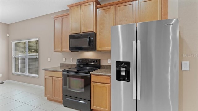 kitchen with light tile patterned floors, light brown cabinets, and black appliances