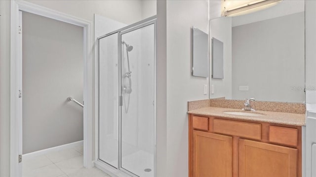 bathroom with tile patterned flooring, vanity, and a shower with shower door