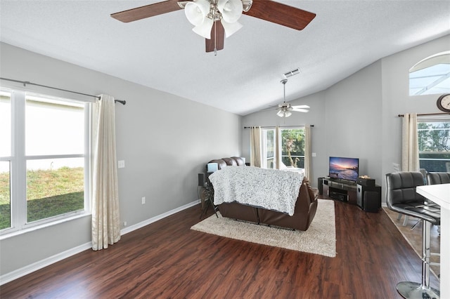 bedroom with a textured ceiling, dark hardwood / wood-style floors, vaulted ceiling, and ceiling fan