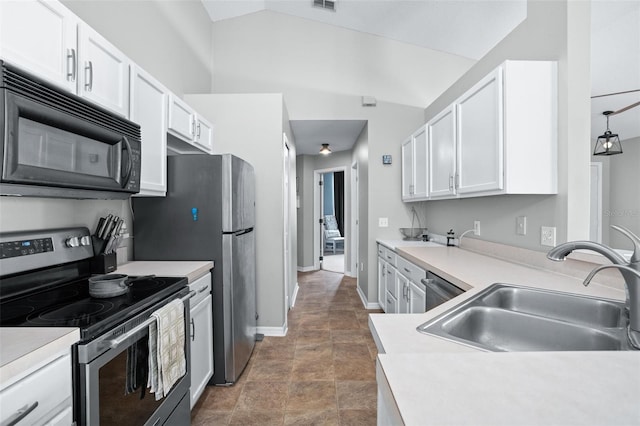 kitchen featuring appliances with stainless steel finishes, white cabinetry, lofted ceiling, and sink