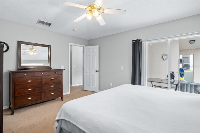 carpeted bedroom featuring a textured ceiling and ceiling fan