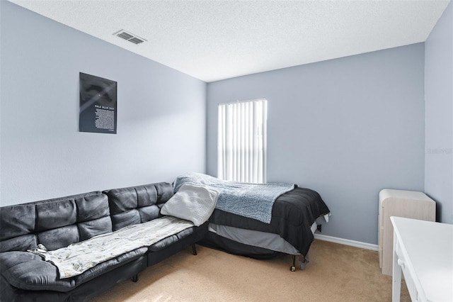 carpeted bedroom featuring a textured ceiling