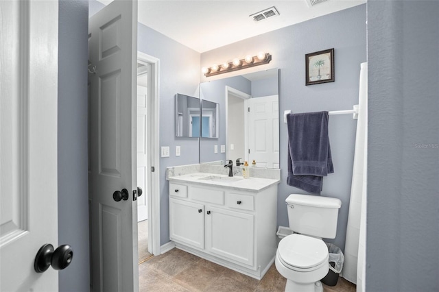 bathroom featuring tile patterned floors, vanity, and toilet