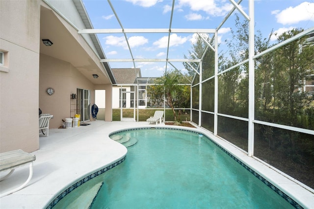 view of swimming pool featuring a lanai and a patio