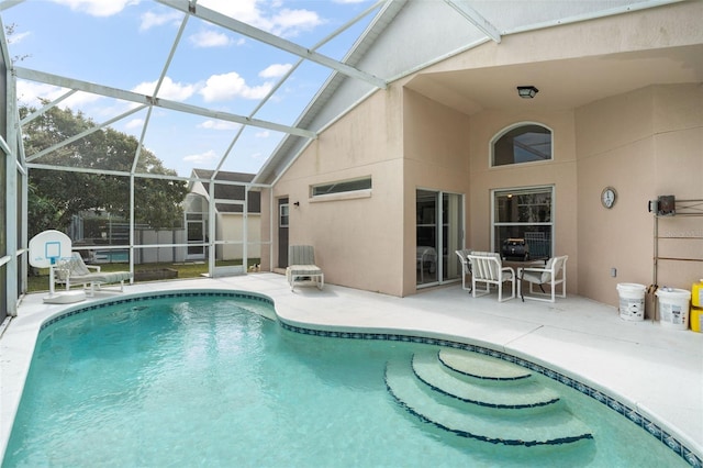 view of swimming pool with a lanai and a patio area