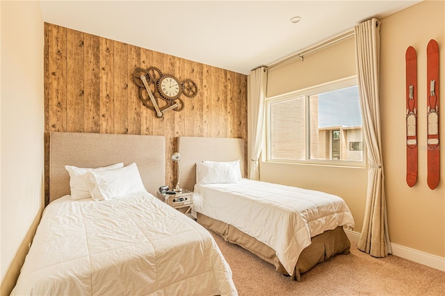 bedroom featuring carpet flooring and wood walls